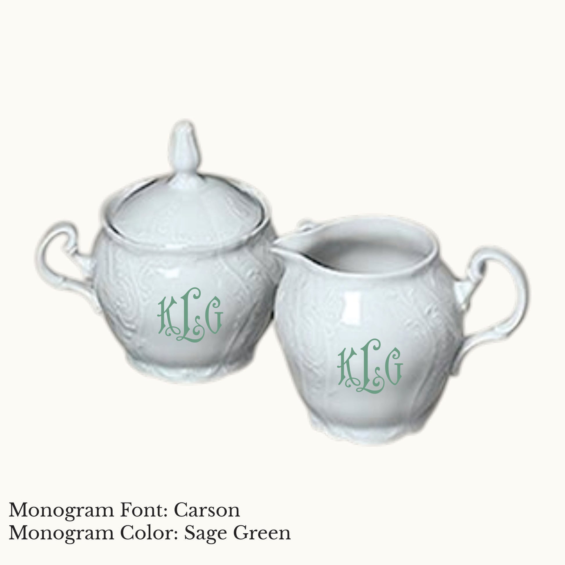 White Bernadotte porcelain cream and sugar set with embossed detailing and Carson three-letter monograms in Sage Green.