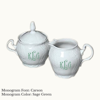 White Bernadotte porcelain cream and sugar set with embossed detailing and Carson three-letter monograms in Sage Green.
