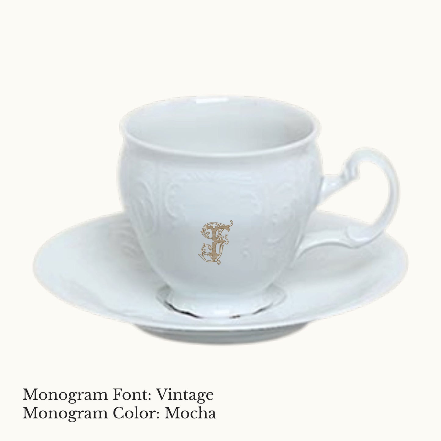 White Bernadotte porcelain cup and saucer with embossed detailing and an ornate custom letter F monogram in Mocha.