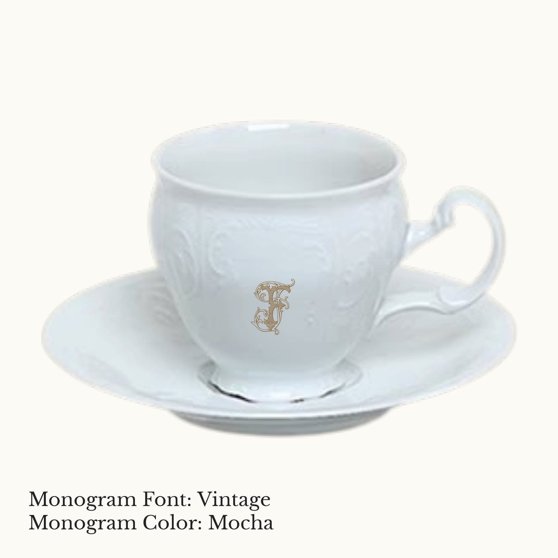 White Bernadotte porcelain cup and saucer with embossed detailing and an ornate custom letter F monogram in Mocha.