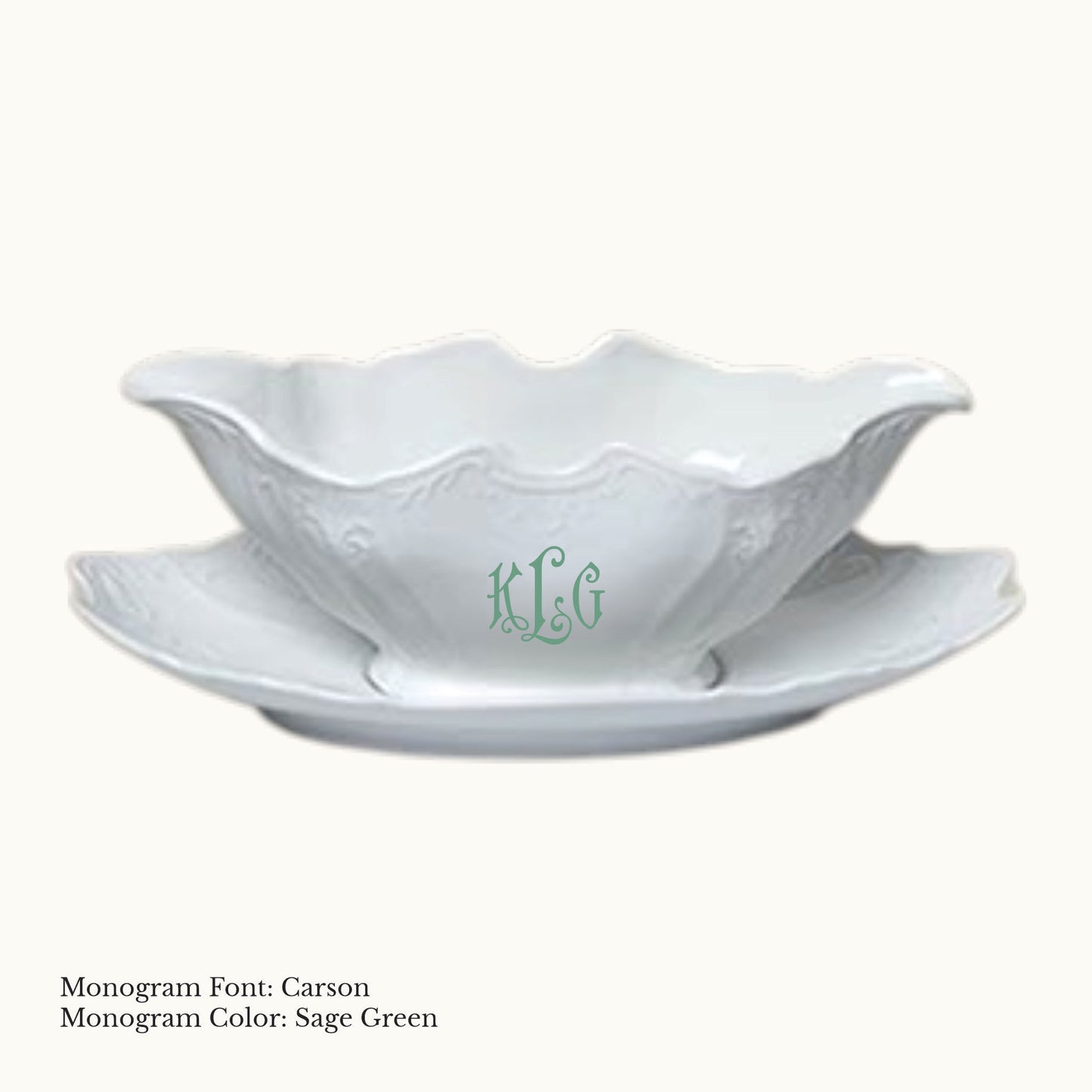 White 14-ounce Bernadotte porcelain gravy boat with an attached tray, embossed detailing, and a Carson monogram in Sage Green.