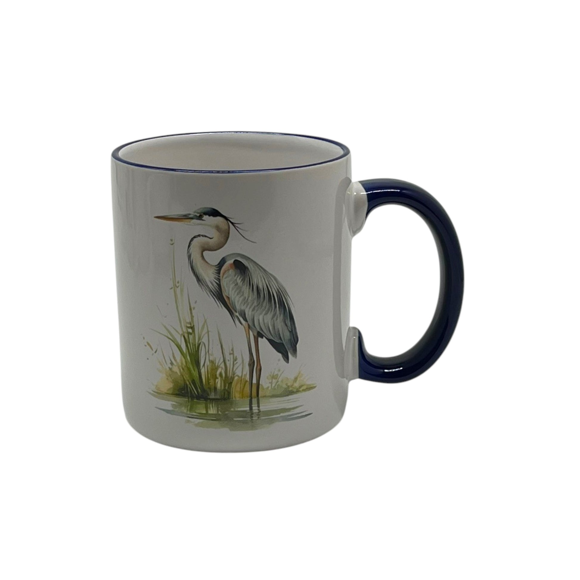 White 12-ounce stoneware mug featuring a graceful blue heron beside marsh grasses with a dark blue handle and coordinating rim.