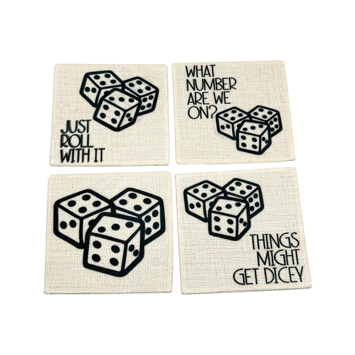 Set of four linen dice coasters with black dice artwork and funny game night sayings including Just Roll With It and Things Might Get Dicey