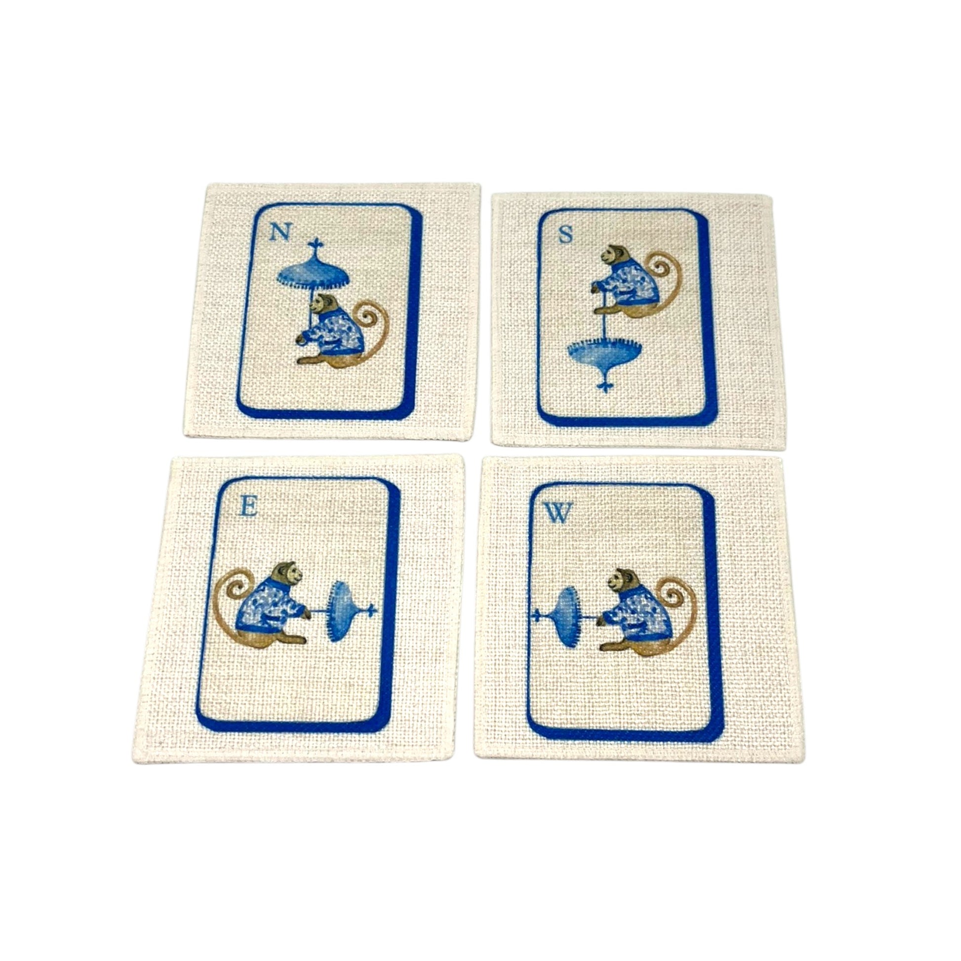 The Four Winds Mahjong linen coaster set of four featuring North South East and West chinoiserie monkeys in blue on natural linen