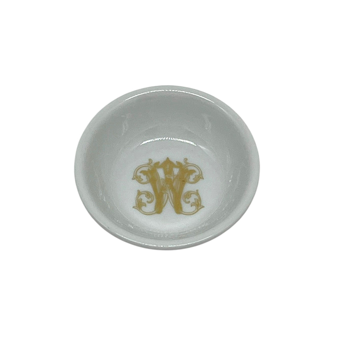 White 2.75 inch ring dish featuring an ornate faux-gold W monogram in the center