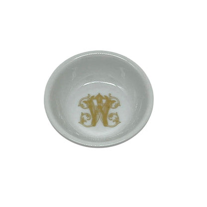 White 2.75 inch ring dish featuring an ornate faux-gold W monogram in the center