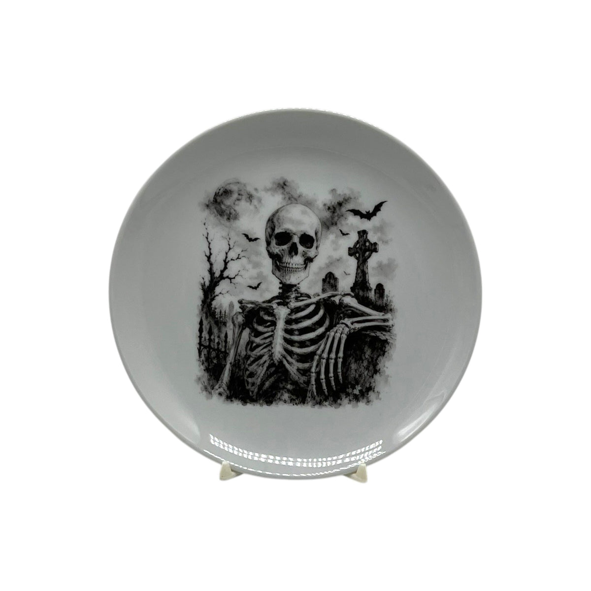 Black and white haunted graveyard skeleton 6 1/4 inch coupe plate with bats and gothic cemetery scene