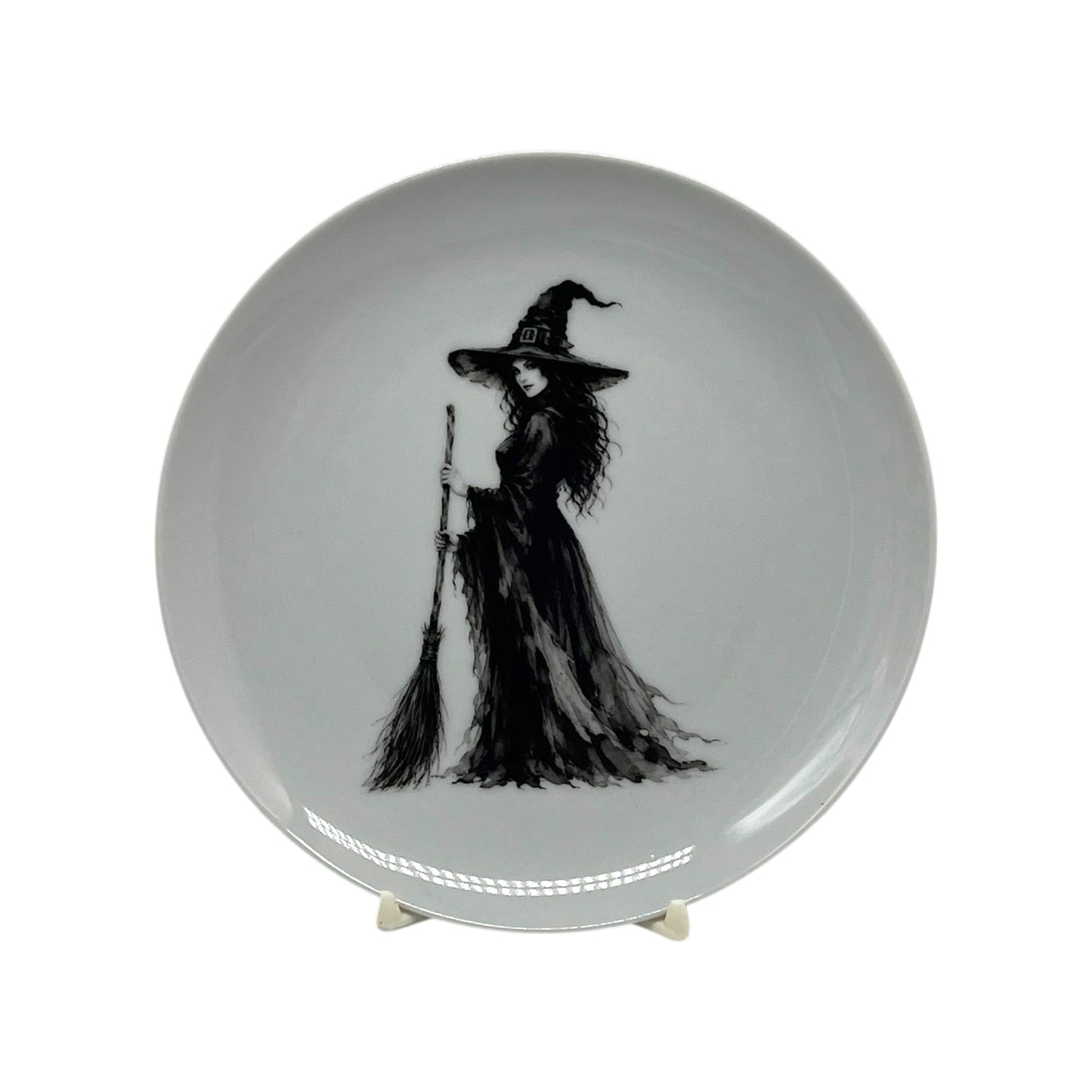 Midnight Witch 6.25 inch Halloween coupe plate featuring black-and-white witch artwork with pointed hat, flowing gown and broom